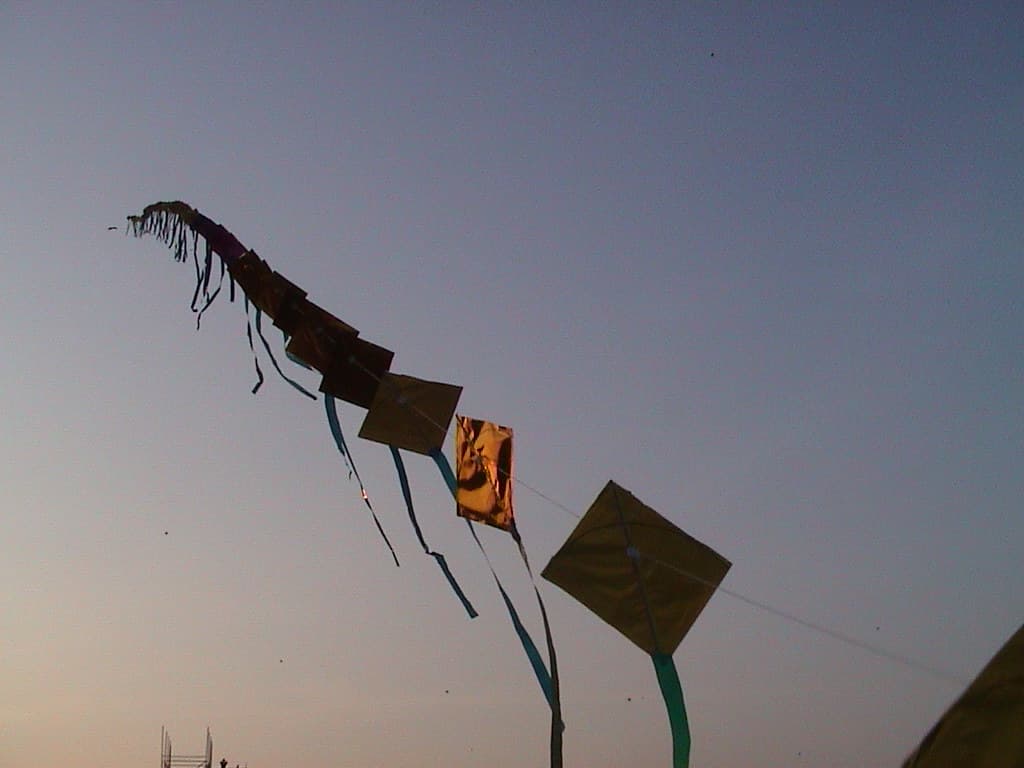 Chain of classic diamond kites flying in the sky