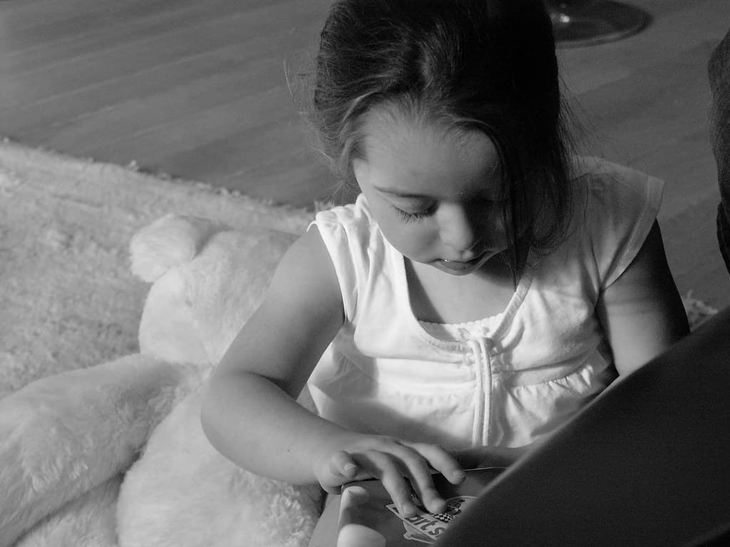 Child playing with a FurReal Friends interactive plush pet