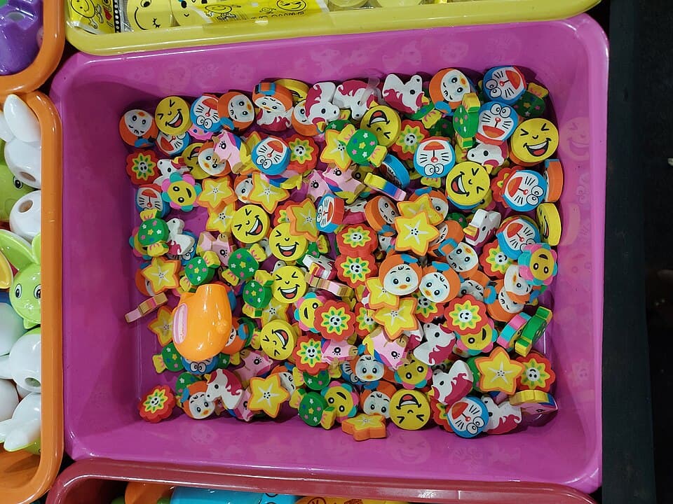 Bin of colorful cartoon-shaped novelty erasers