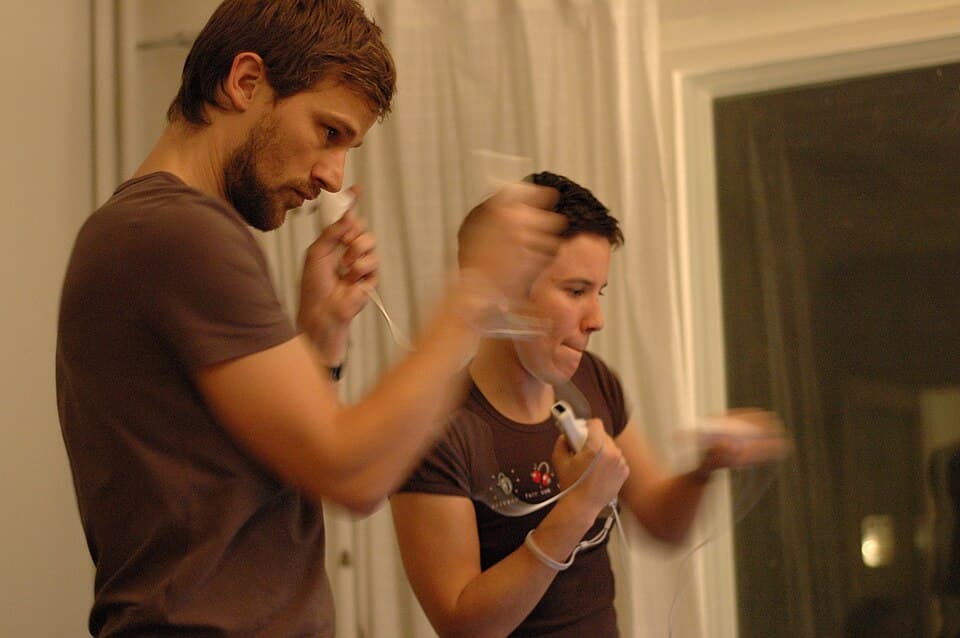 Two players boxing in Wii Sports with Wii Remotes